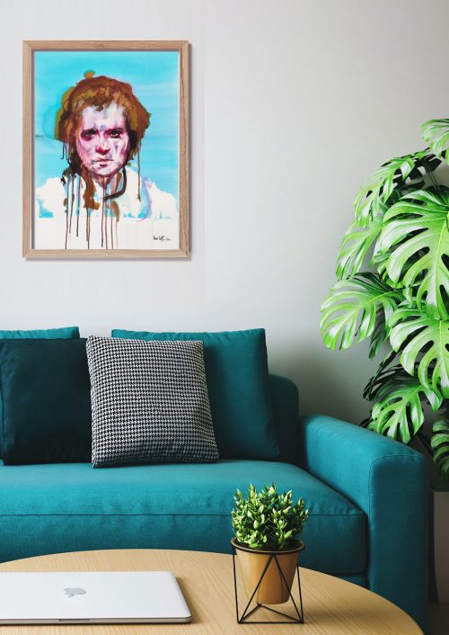 Portrait encadré au-dessus d'un sofa et plante verte